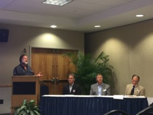 The U.S. Green Building Council held a community forum at the University of North Florida recently. From left, UNF's Dr. Lambert questions attorney George Cavros of the Southern Alliance for Clean Energy, Pete Wilking of A1A Solar, and Dr. Todd Sacks of the Borland-Groover Clinic adn Physicians for Social Responsibility. (photo: Lisa Grubba)